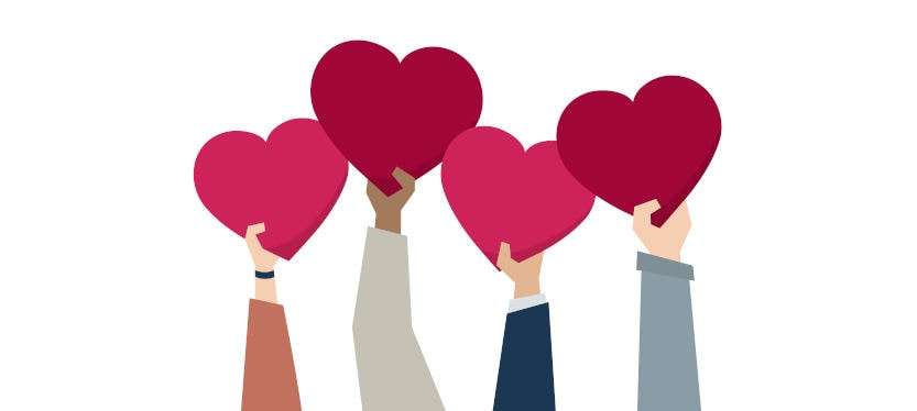 employees holding hearts as commitment
