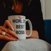 Woman holding a "World best Boss" mug.